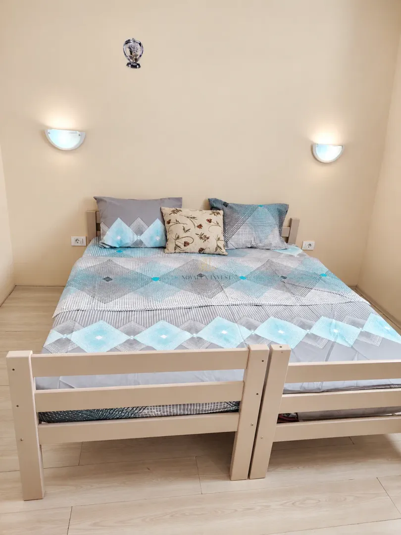 Bedroom with a double bed and wall lamps.