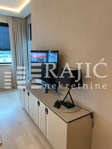 Modern living room with a TV and a credenza.