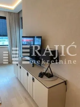 Modern living room with a TV and a credenza. - image 10