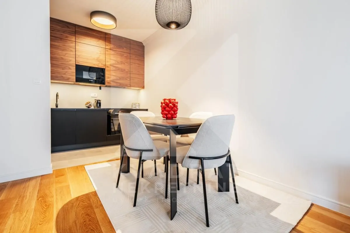 Modern kitchen with a dining table and chairs.