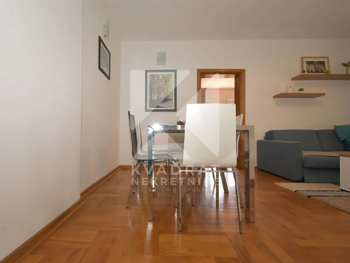 Living room with a dining table and a sofa.