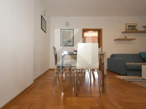 Living room with a dining table and a sofa. - image 4