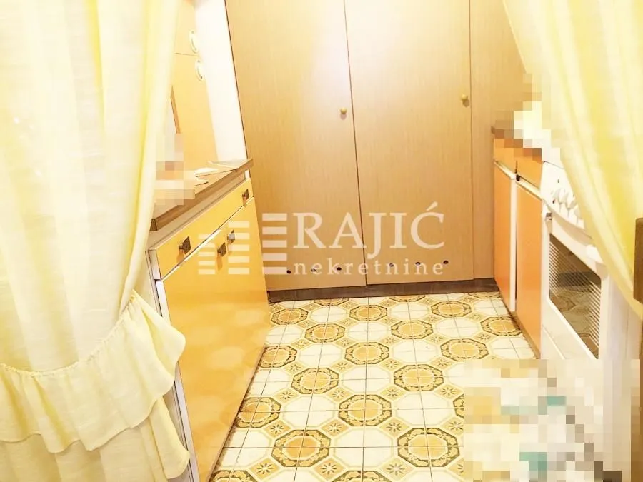 Small kitchen with cabinets and a built-in oven.
