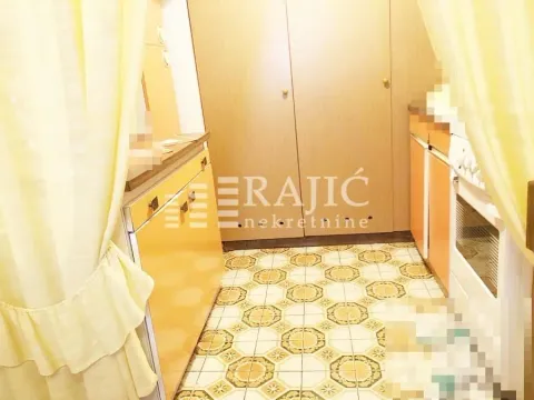 Small kitchen with cabinets and a built-in oven. - image 14