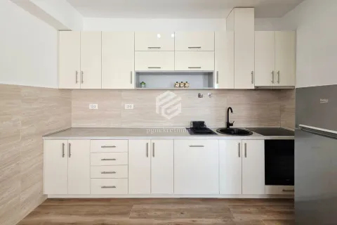 Kitchen equipped with white cabinets and appliances. - image 8