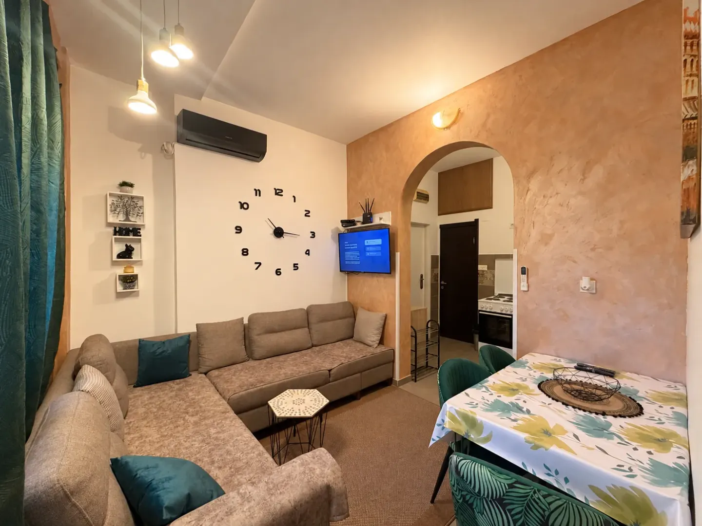 Living room with a sectional sofa and a dining table.