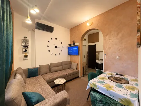 Living room with a sectional sofa and a dining table. - image 4