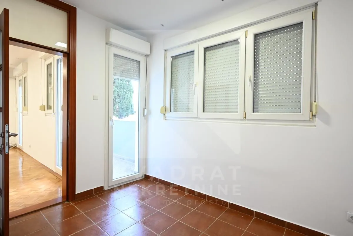 Enclosed terrace with ceramic tile flooring and exterior view.