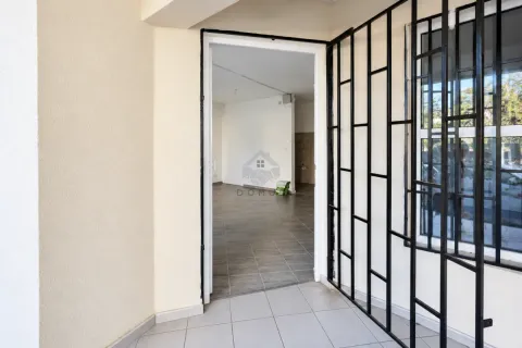Exterior entrance to the property with protective security bars on the window. - image 12