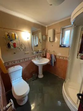 Kupatilo opremljeno umivaonikom, WC šoljom, tuš kabinom i ogledalom. - image 18