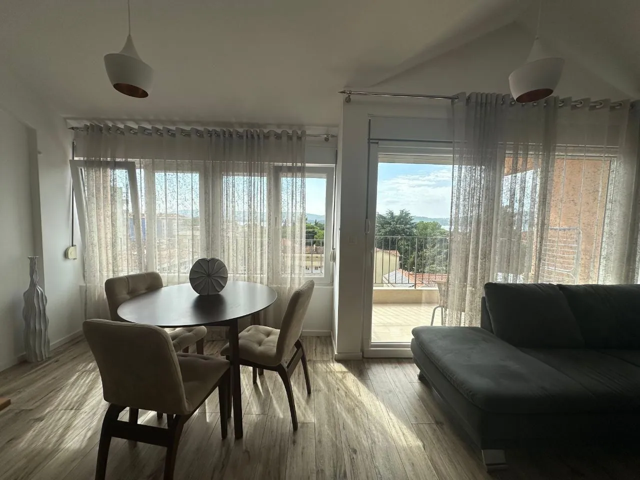 Living room with dining area and terrace access.