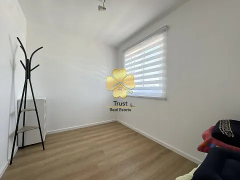 Empty room with laminate flooring and a clothes rack. - image 13