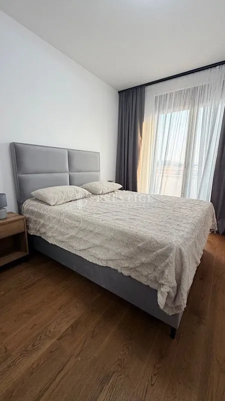 Modern bedroom with a double bed and bright interior.