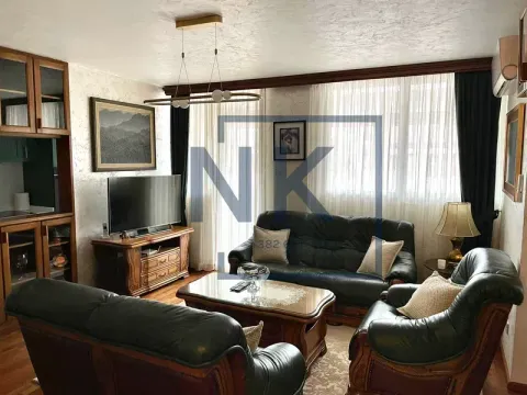 Living room with a sofa set, TV, and a dining area in the background. - image 3