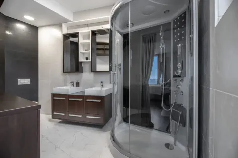 Modern bathroom with a shower cabin and double washbasin. - image 11