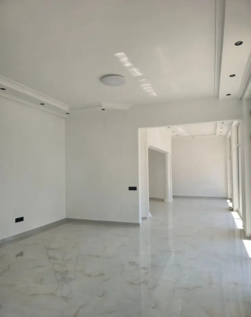 Empty bright room with tiled flooring.