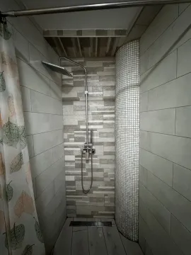 Shower cabin with ceramic tiles and a shower set. - image 5