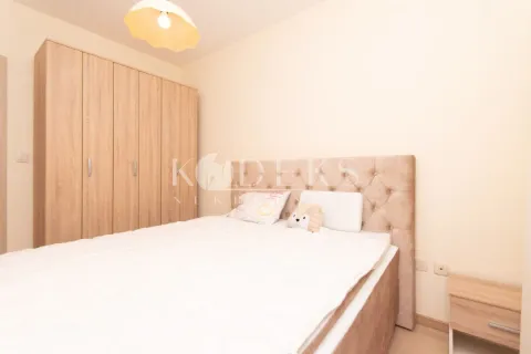 Furnished bedroom with a double bed and a wooden wardrobe. - image 6