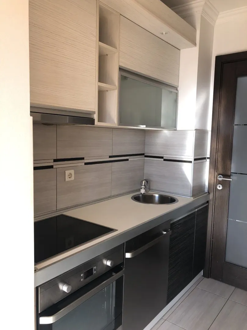 A bright and functional kitchen with built-in appliances.