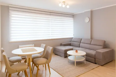 Living room with a sectional sofa, dining table and chairs. - image 2