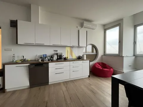 Modern kitchen with white cabinetry and a dining area. - image 25