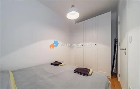 Small bedroom with a double bed and a white wardrobe. - image 9