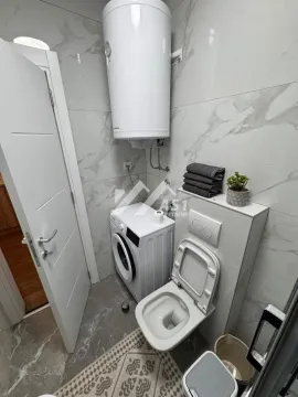 Savremeno opremljeno kupatilo sa WC šoljom, veš mašinom i bojlerom. - image 4