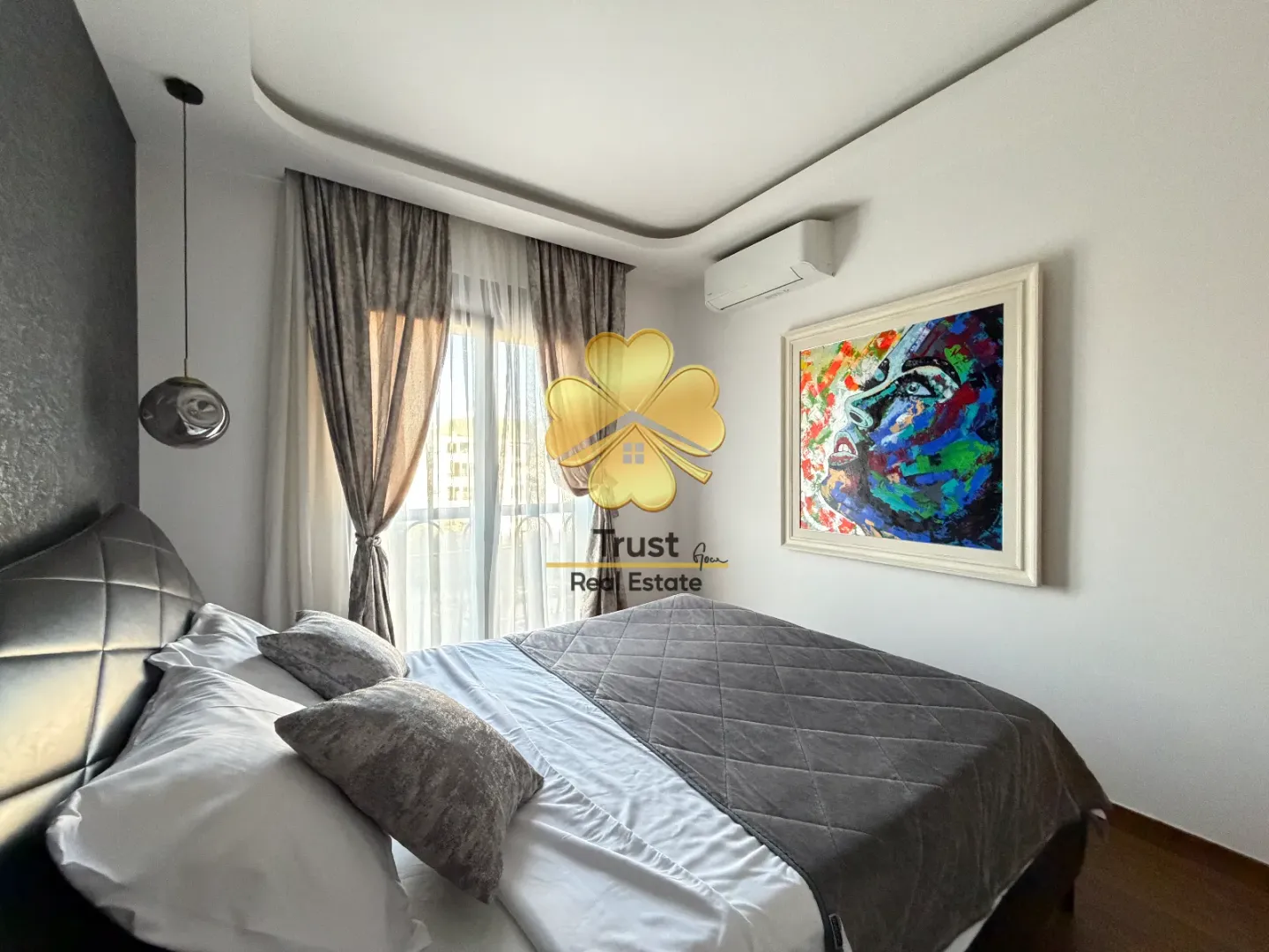 Modern bedroom with a double bed, artwork, and access to the terrace.