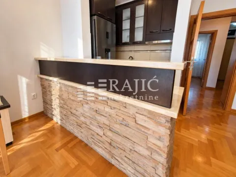 Modern kitchen with a bar counter and wooden elements. - image 5