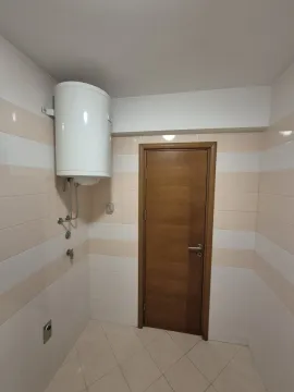 Bathroom with a water heater and a wooden door. - image 7