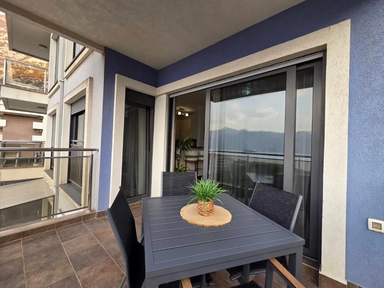 Spacious balcony with outdoor seating and sea view.