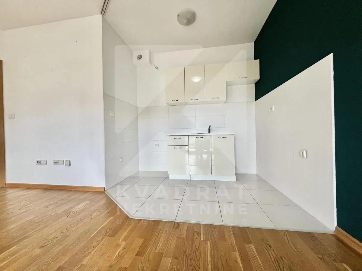 Small kitchen with white cabinets and a sink.