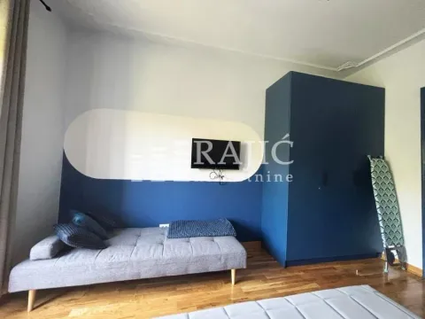 Smaller bedroom with a bed, wardrobe, and wooden floor. - image 4
