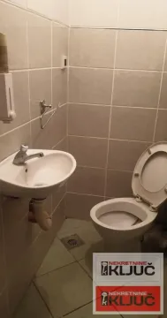 Smaller tiled bathroom with a washbasin and a toilet. - image 8