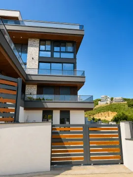 Exterior of a modern residential building with a gate and terraces. - image 6