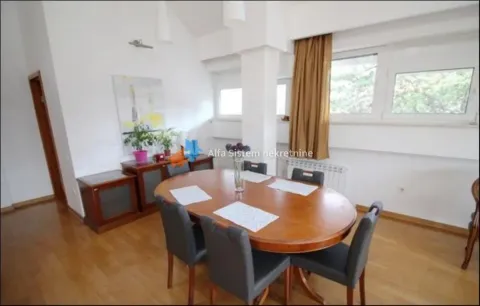 Dining area with a large wooden table and chairs. - image 16