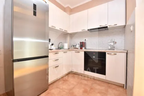 Kitchen with white cabinetry, built-in oven, and a large refrigerator. - image 5