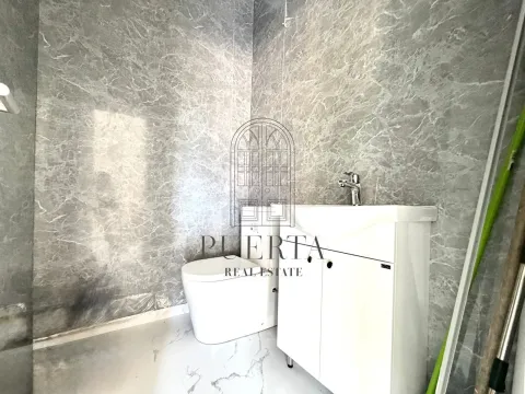 Small bathroom with a vanity and toilet. - image 6