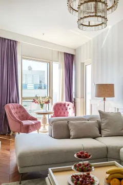 Spacious and bright living room with a sofa and armchairs. - image 4