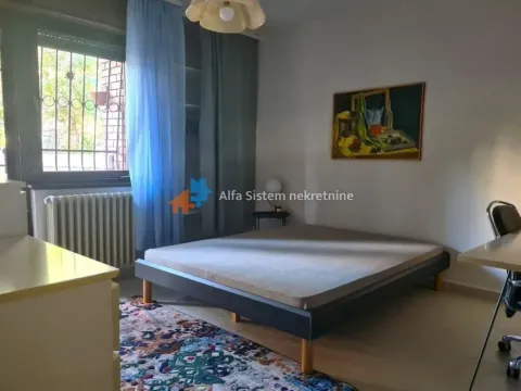 Furnished bedroom with a double bed, window, and a painting on the wall. - image 16