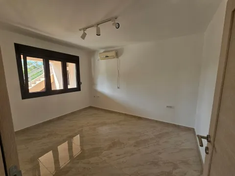 An empty, bright room with tiled floors and an air conditioning unit. - image 8