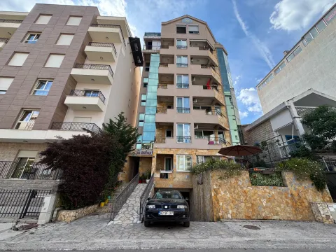 Front view of the apartment building with an entrance and ground-floor parking. - image 16