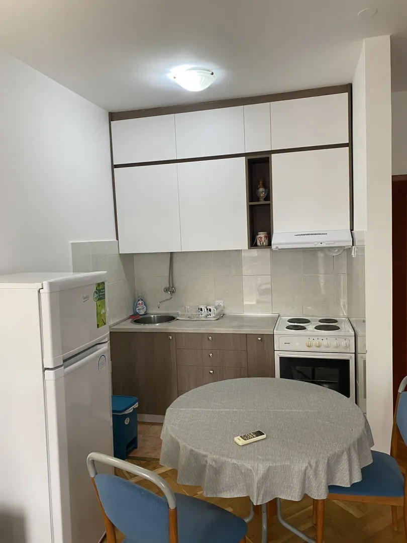 Small functional kitchen with a dining table.