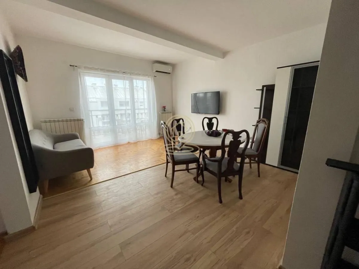 Living room with a dining table and a sofa.