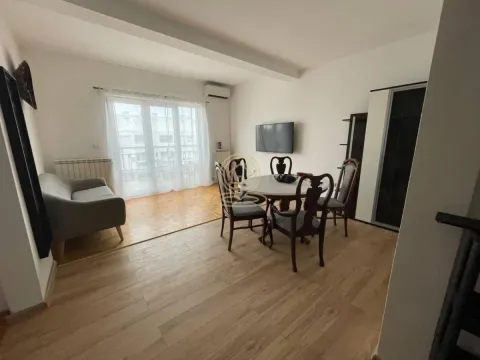 Living room with a dining table and a sofa. - image 10