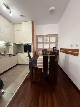 Dining area connected to the kitchen in bright tones with built-in appliances. - image 4