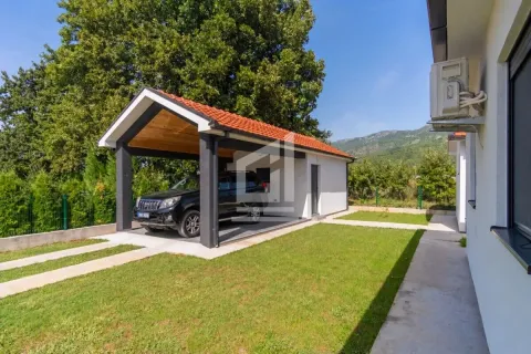 Covered parking space with a car in the yard of the house. - image 2
