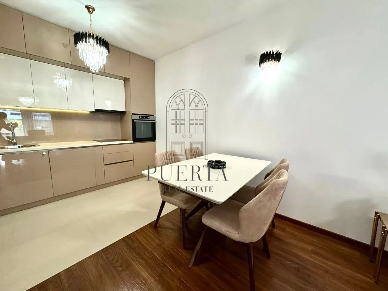Modern kitchen with dining table and chairs.