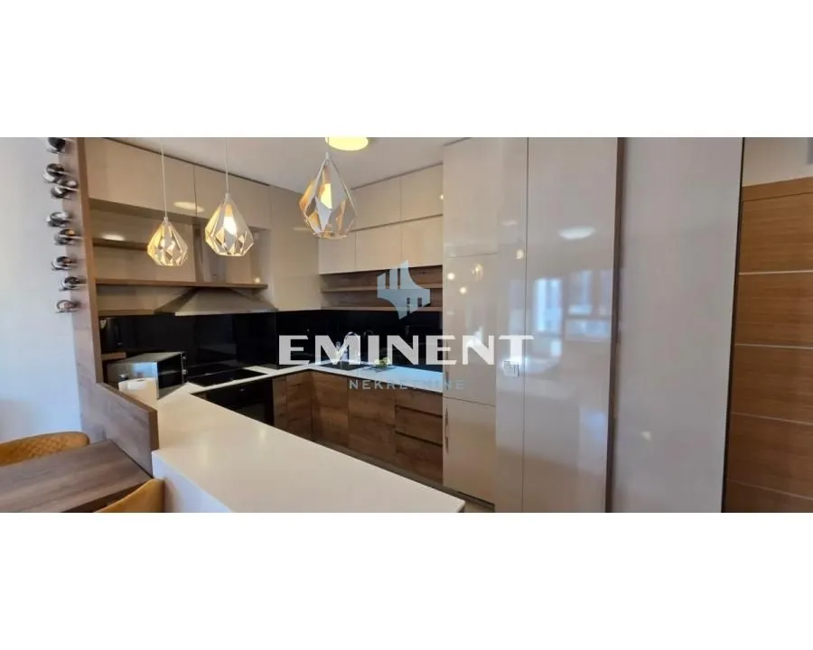 Modern kitchen with built-in appliances and a breakfast bar.