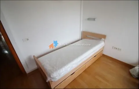 Small bedroom with a wooden bed and parquet flooring. - image 24